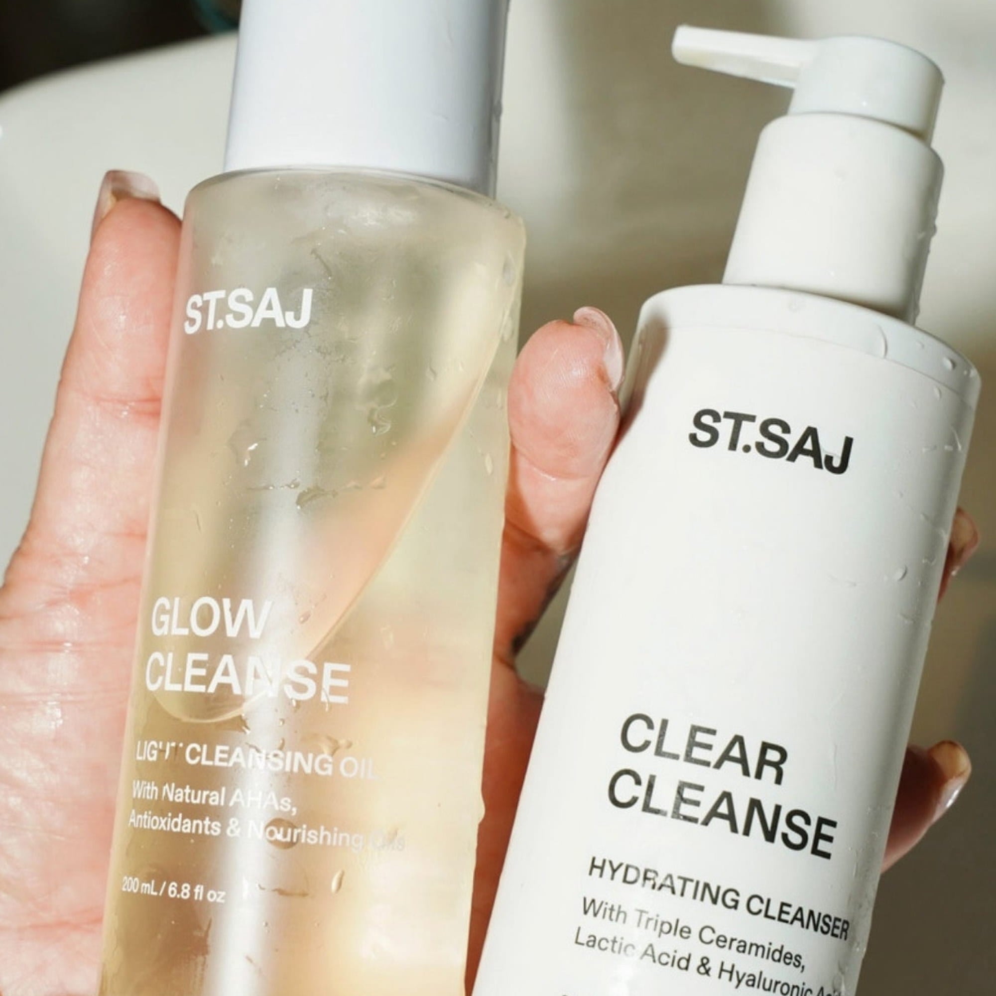 Hand holding ST.SAJ Glow Cleanse and Clear Cleanse double cleanse duo