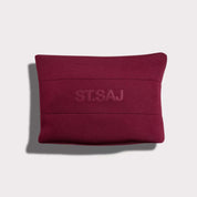 ST.SAJ Serious Skin Lover Bag - burgundy neoprene cosmetic bag flat lay on grey background