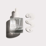 ST.SAJ Hyaluronic Smoothing Complex serum bottle with water droplets on a grey background