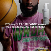 ST.SAJ Clear Cleanse - model holding cleanser, 70% say Clear Cleanse makes skin feel clean but not tight