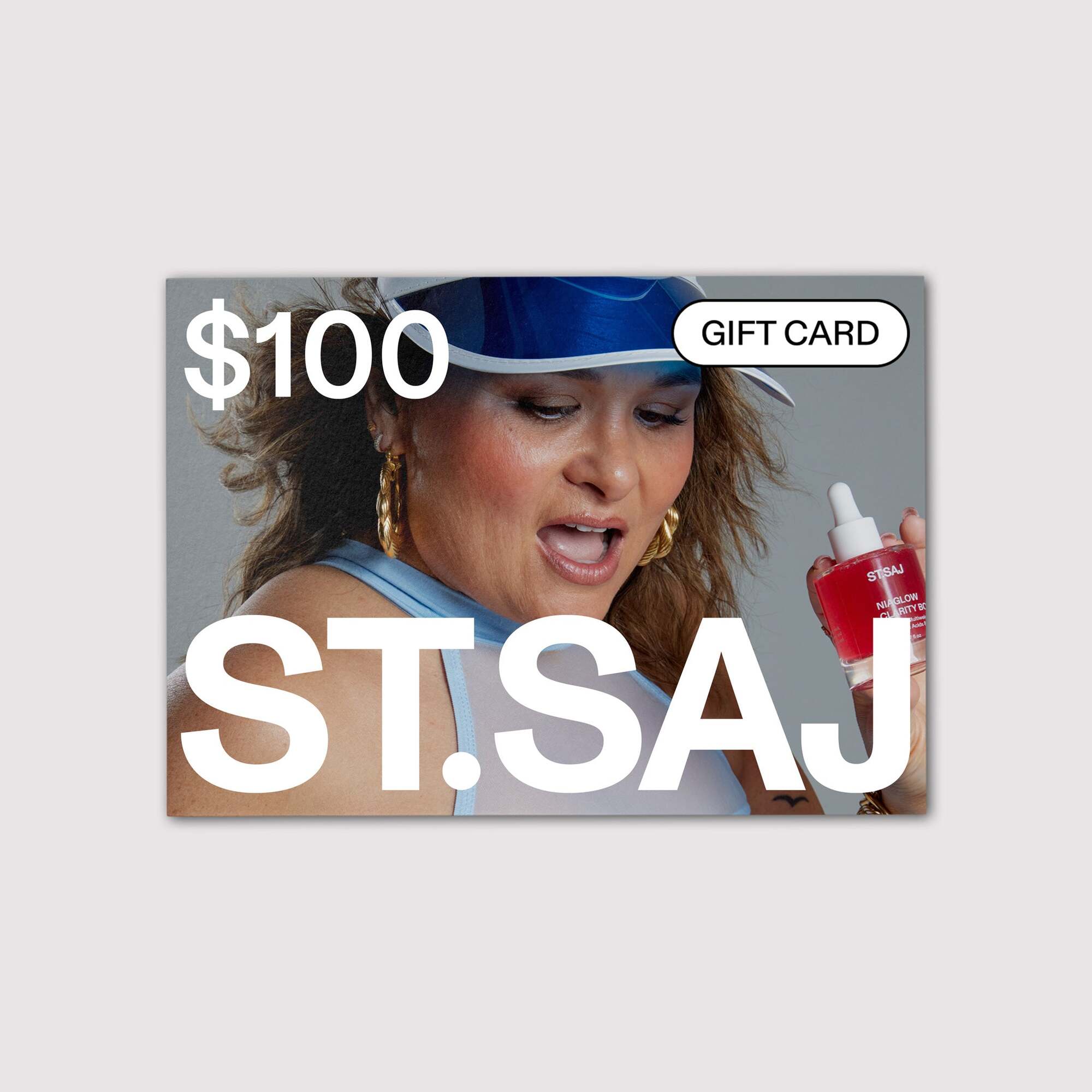 ST.SAJ $100 gift card with Emmylou in blue cap holding product.