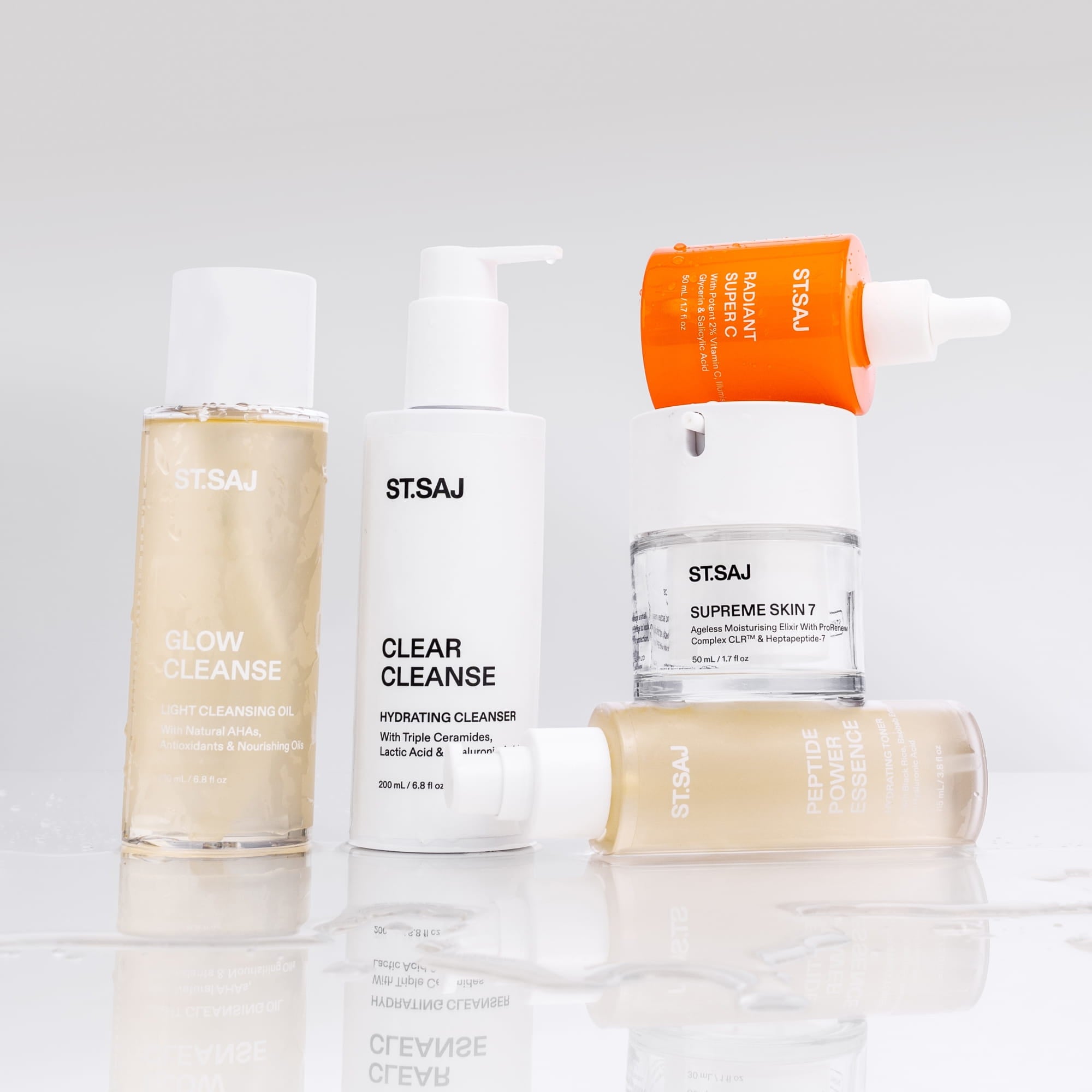 ST.SAJ Glow Kit - Glow Cleanse, Clear Cleanse, Peptide Power Essence, Radiant Super C and Supreme Skin 7 product flat lay