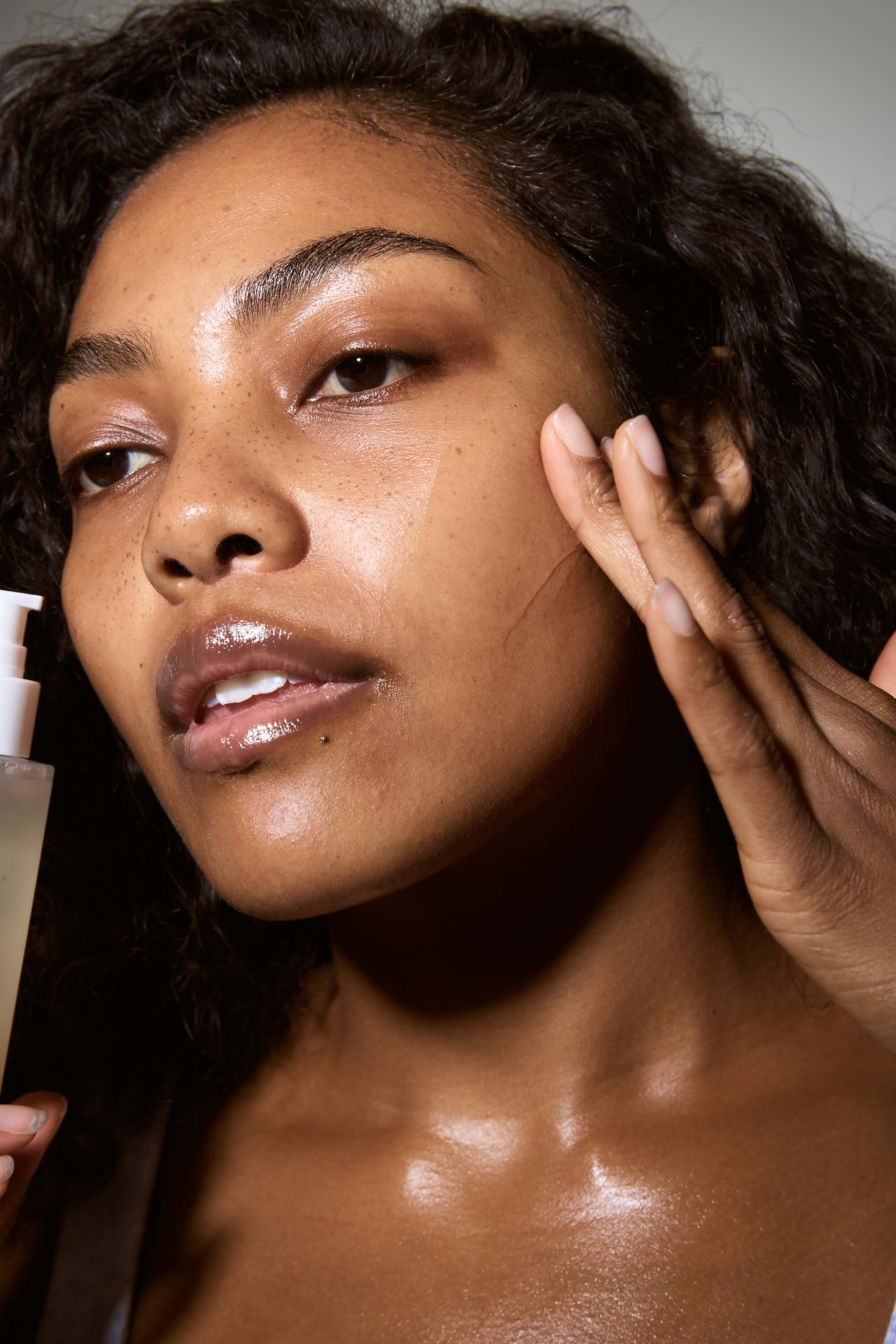 Woman applying skincare product to her face