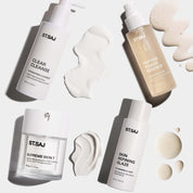 ST.SAJ Skin Refining Routine flat lay - Clear Cleanse, Peptide Power Essence, Supreme Skin 7 and Skin Refining Glaze with cream swatches on grey background.