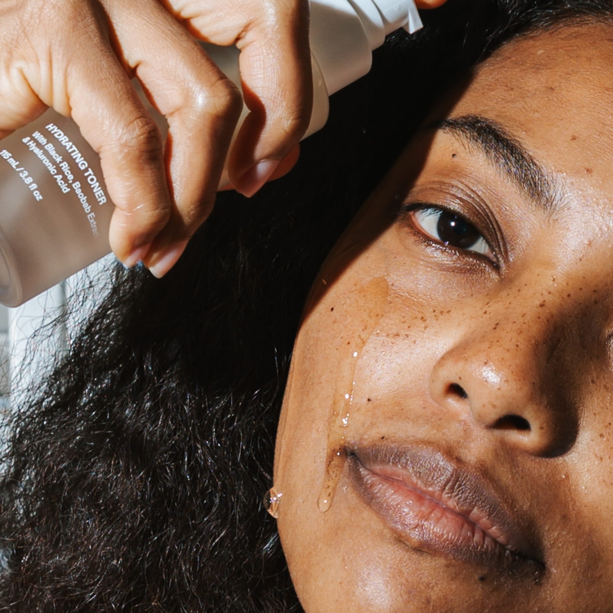 Close up of woman applying ST.SAJ Peptide Power Essence to face - hydrating peptide toner Australia