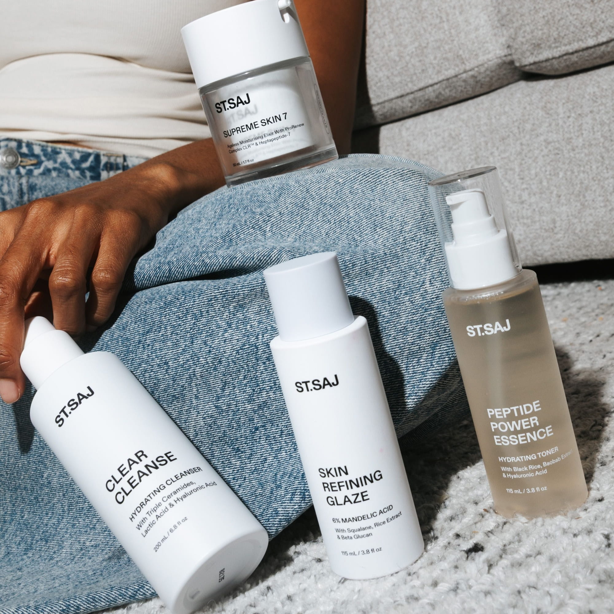 ST.SAJ Skin Refining Routine - Clear Cleanse, Skin Refining Glaze, Peptide Power Essence and Supreme Skin 7 against denim background - Australian skincare