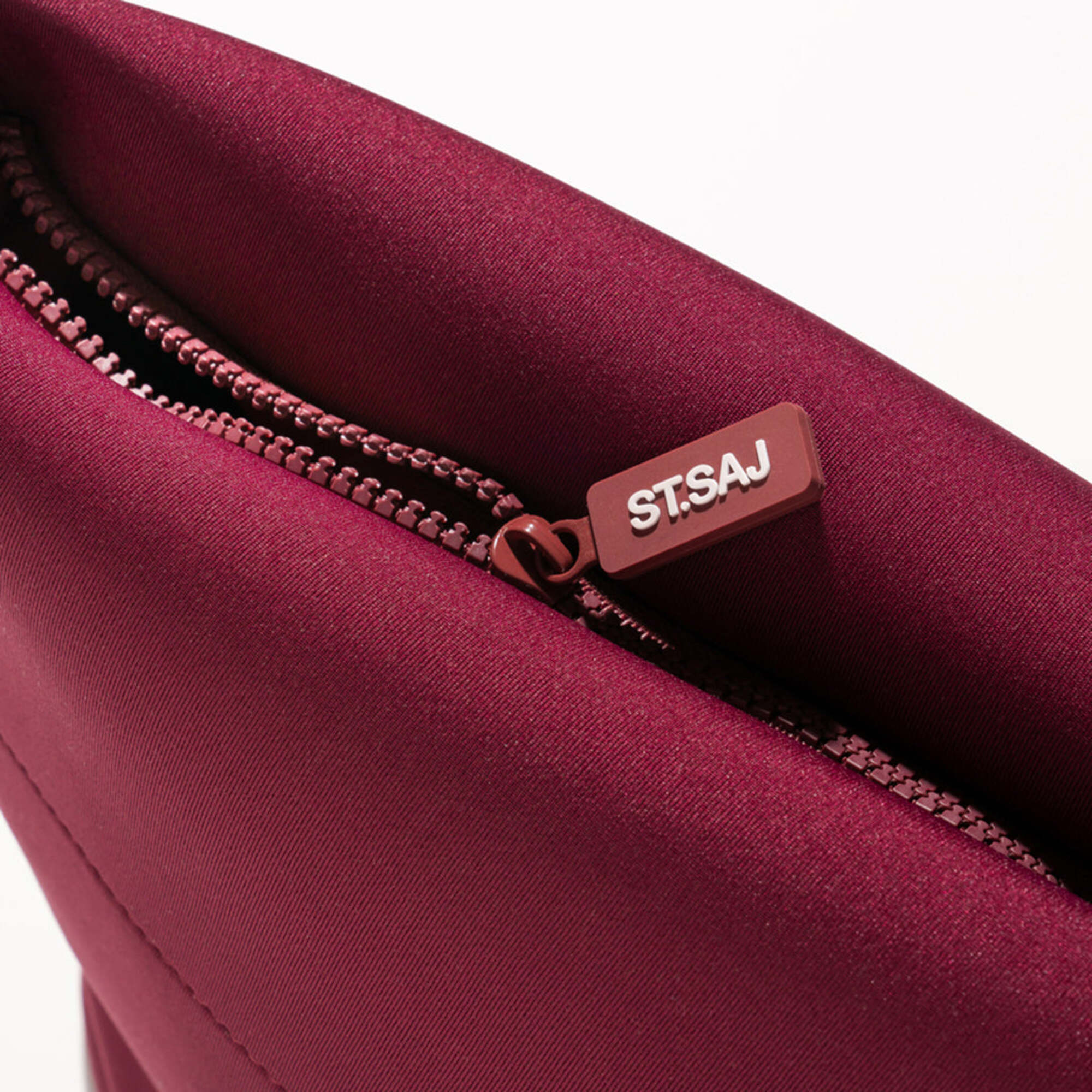 ST.SAJ Serious Skin Lover Bag - close-up of rose gold zip and ST.SAJ branded zip pull detail