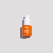 An orange bottle of STSAJ Radiant Super C serum with a white pump dispenser, centered on a light gray background with a soft shadow.