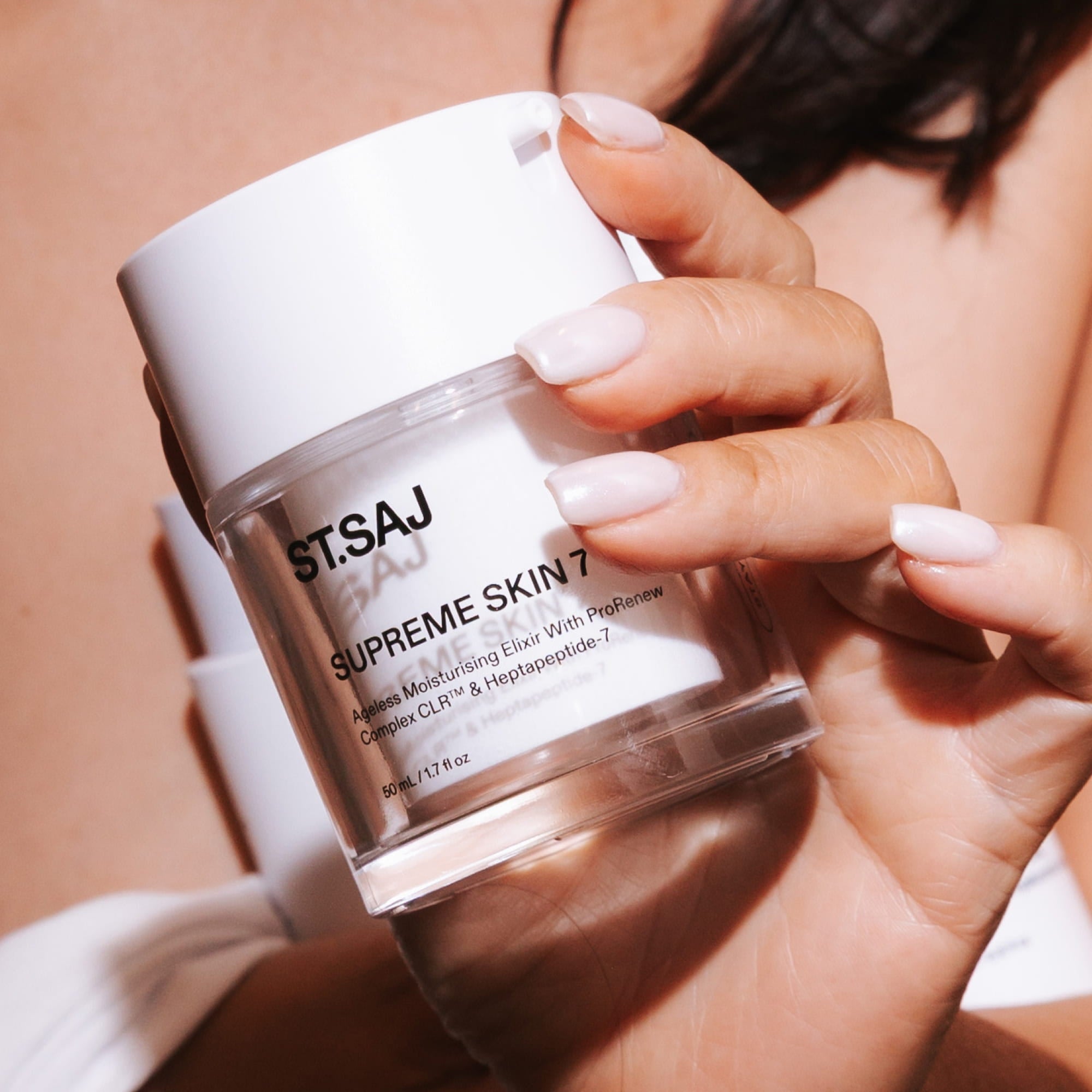 Hand holding ST.SAJ Supreme Skin 7 barrier-repairing moisturiser - Australian skincare